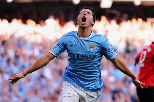 Samir Nasri celebrates as he scores his team's fourth goal during the Barclays Premier League match between Manchester City and Manchester United at the Etihad Stadium on September 22, 2013 in Manchester, England. (Getty Images)